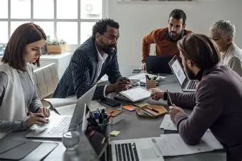 Team discussing project strategy in a business meeting room